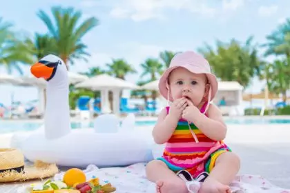 Baby eats fruit on vacation. Selective focus.